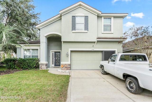 view of front of house featuring a front yard and a garage