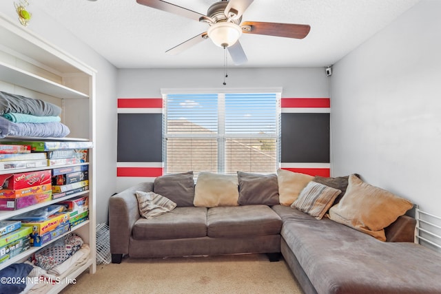 carpeted living room with ceiling fan and a textured ceiling