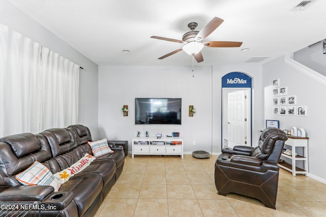 living room featuring light tile patterned floors and ceiling fan