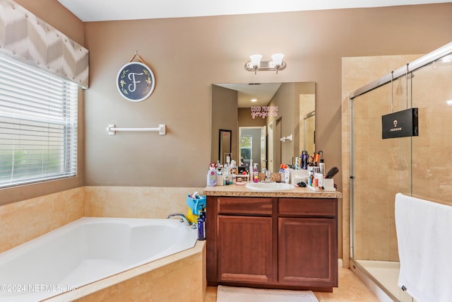 bathroom with vanity and shower with separate bathtub