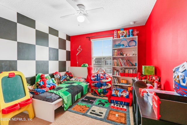 bedroom featuring ceiling fan, carpet floors, and a textured ceiling