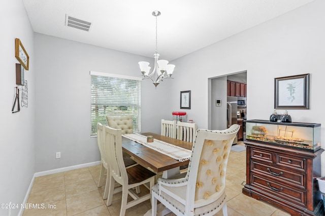 tiled dining space with an inviting chandelier