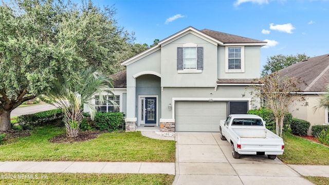 front of property featuring a garage and a front yard