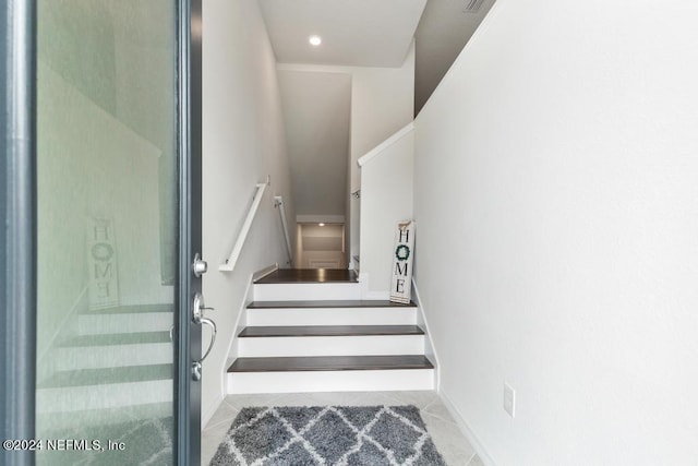 stairway with tile patterned flooring