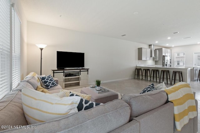 tiled living room with plenty of natural light