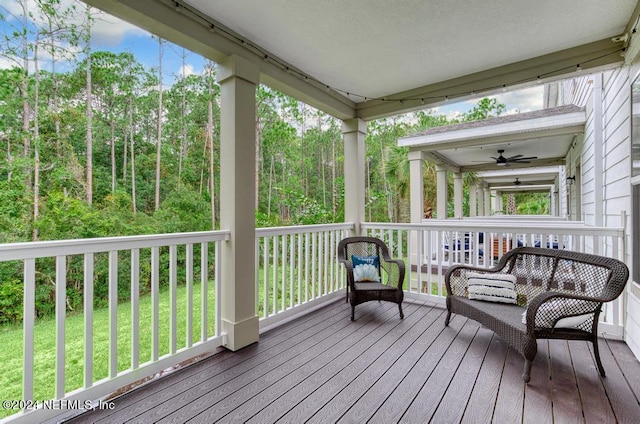 wooden terrace featuring ceiling fan