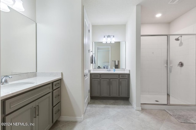 bathroom featuring walk in shower, tile patterned floors, and vanity