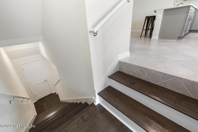 staircase with wood-type flooring