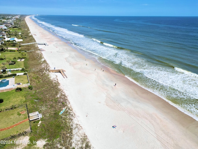 drone / aerial view with a beach view and a water view