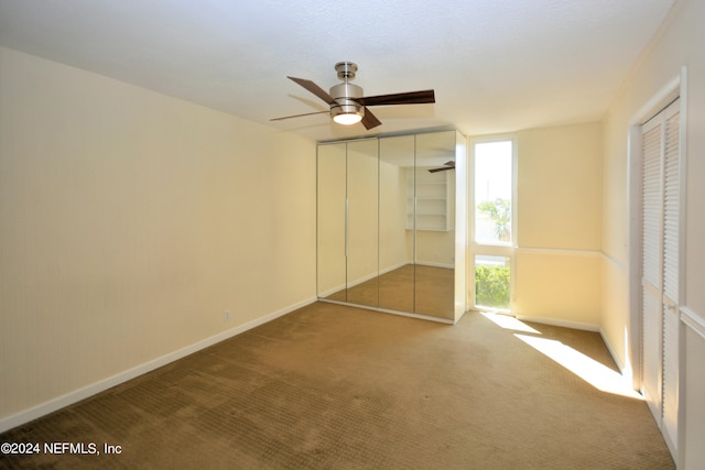 unfurnished bedroom with ceiling fan and carpet floors