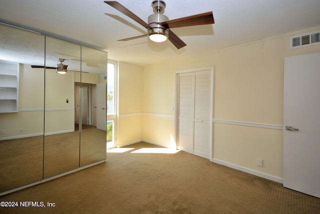 unfurnished bedroom with carpet flooring and ceiling fan