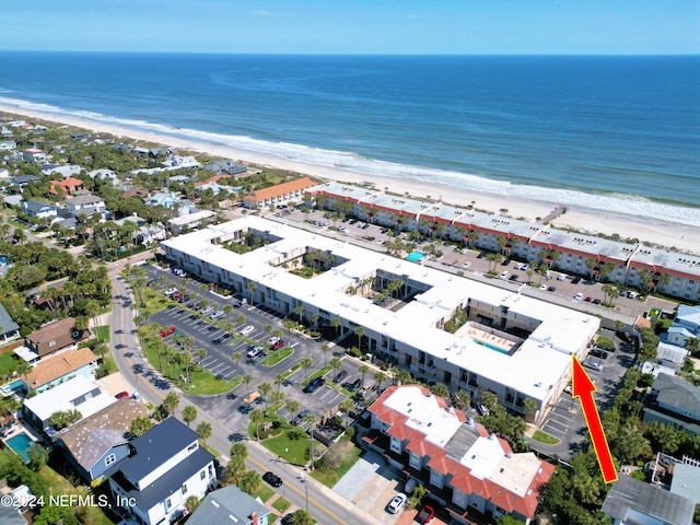 aerial view with a water view and a beach view