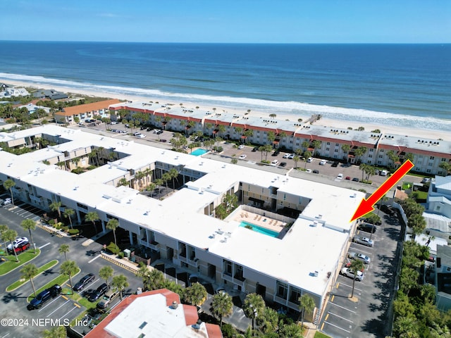 aerial view with a water view and a beach view