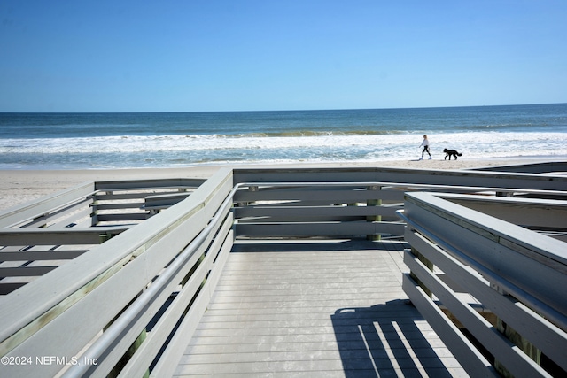 view of community with a beach view and a water view