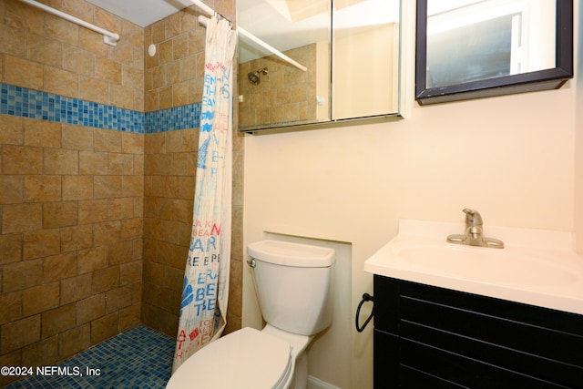 bathroom with curtained shower, vanity, and toilet