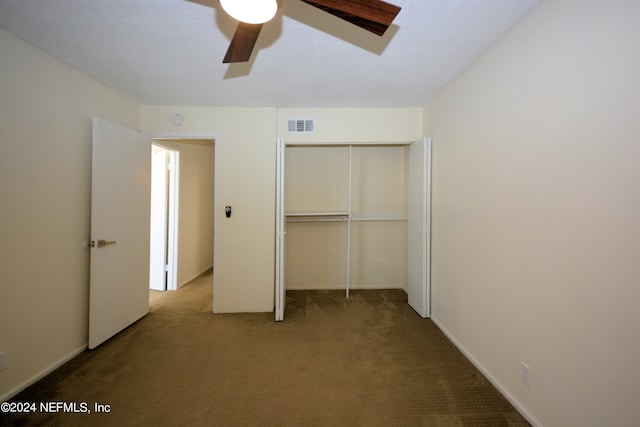 unfurnished bedroom featuring ceiling fan, a closet, and carpet flooring