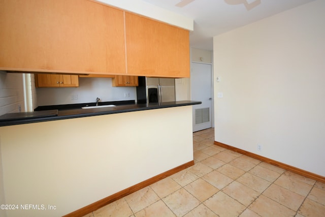 kitchen with stainless steel refrigerator with ice dispenser and sink