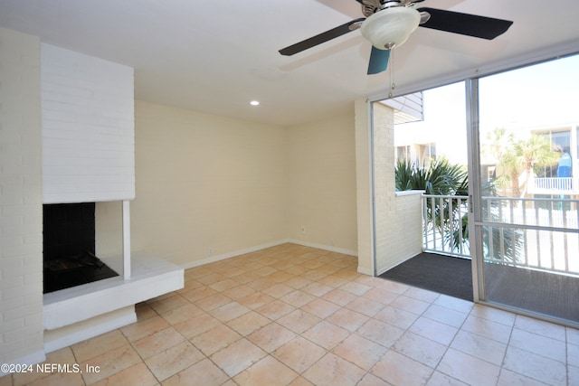 unfurnished living room with ceiling fan, a fireplace, and a healthy amount of sunlight