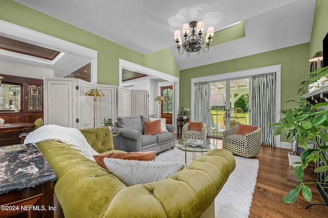 living room featuring a notable chandelier, lofted ceiling, and dark hardwood / wood-style flooring