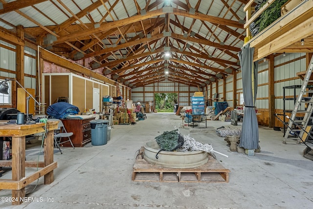 misc room featuring high vaulted ceiling and concrete floors