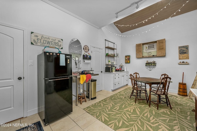 tiled dining space with crown molding and rail lighting