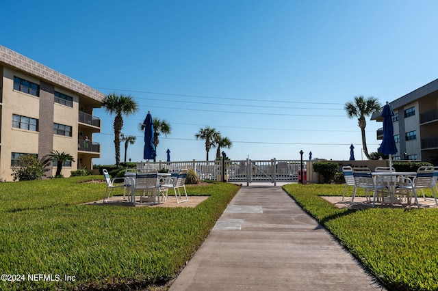 surrounding community with a yard and a patio