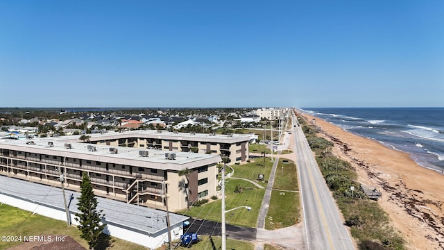 drone / aerial view featuring a water view and a beach view