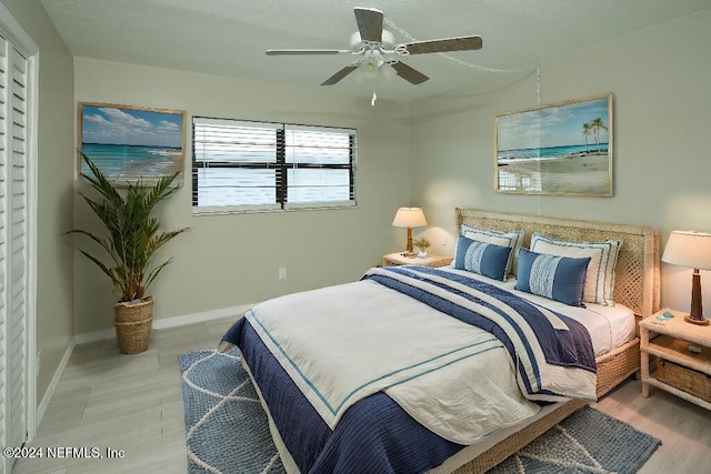 bedroom with ceiling fan and light hardwood / wood-style flooring