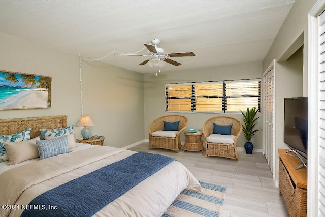 bedroom with light hardwood / wood-style flooring and ceiling fan