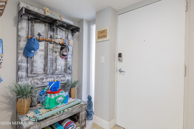 doorway featuring a textured ceiling