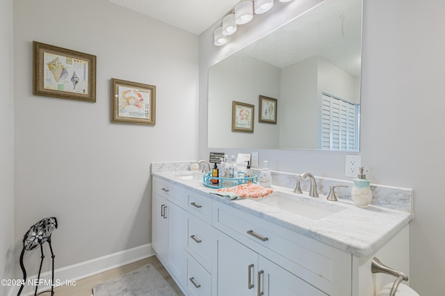 bathroom with a textured ceiling and vanity