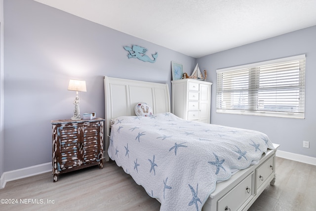 bedroom with light hardwood / wood-style floors