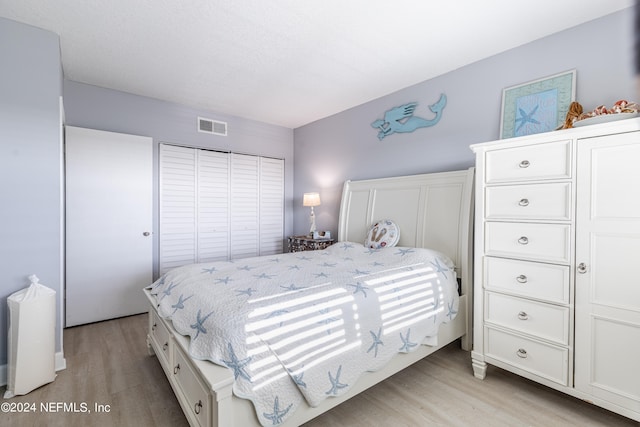 bedroom featuring light hardwood / wood-style flooring and a closet