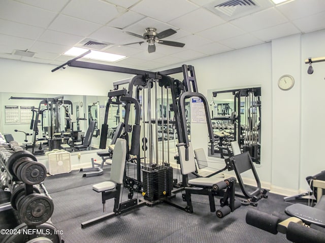 workout area with a drop ceiling and ceiling fan