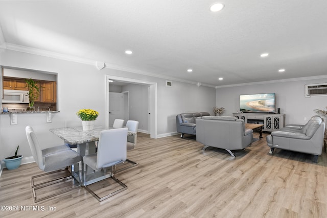 dining room with ornamental molding, light hardwood / wood-style floors, and a wall mounted air conditioner