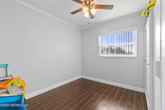 spare room featuring ceiling fan, ornamental molding, and dark hardwood / wood-style flooring