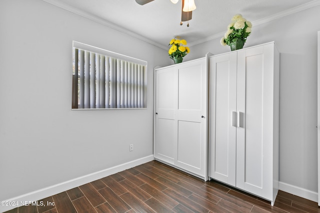 unfurnished bedroom featuring ornamental molding, ceiling fan, and dark wood-type flooring