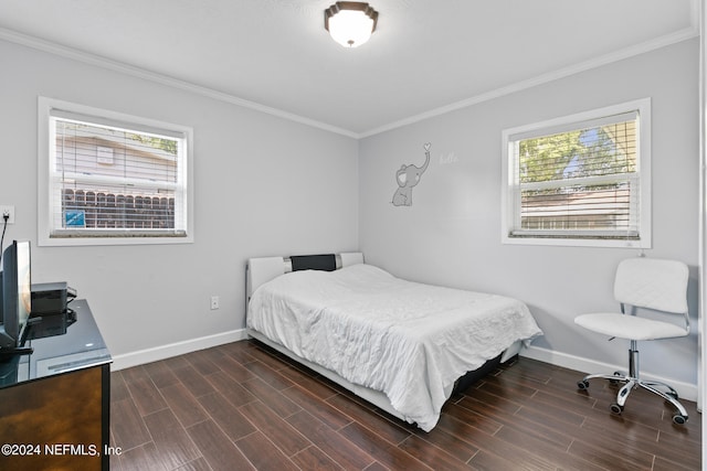 bedroom featuring ornamental molding, dark wood-type flooring, and multiple windows