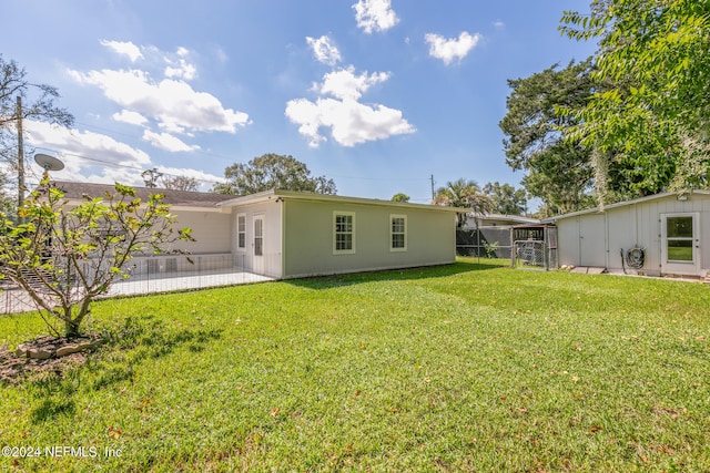 back of house featuring a yard and a patio