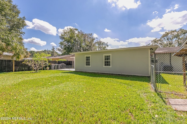 rear view of property with a yard