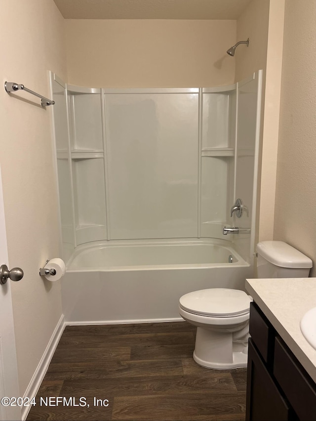 full bathroom featuring tub / shower combination, hardwood / wood-style floors, toilet, and vanity