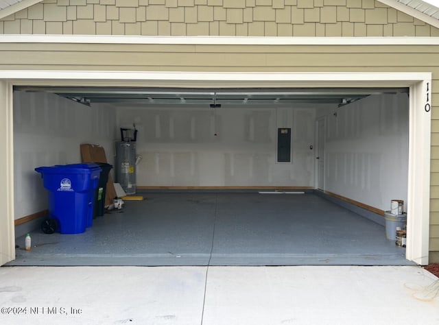 garage with water heater and electric panel