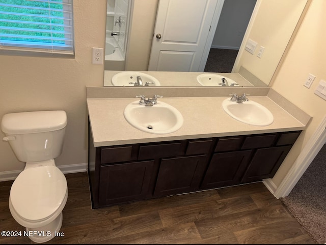 bathroom featuring vanity, hardwood / wood-style floors, and toilet