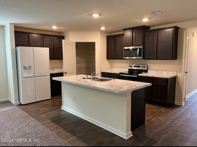 kitchen featuring an island with sink, appliances with stainless steel finishes, dark wood-type flooring, and sink