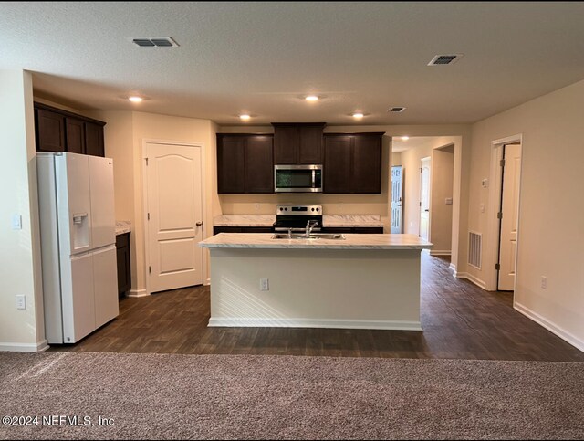 kitchen featuring an island with sink, dark brown cabinets, and stainless steel appliances