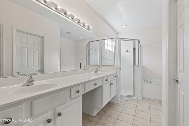 bathroom with plus walk in shower, tile patterned floors, a textured ceiling, and vanity