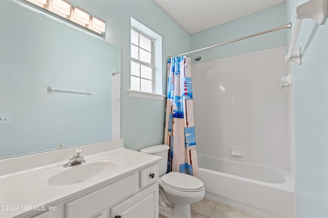 full bathroom featuring shower / bath combo with shower curtain, tile patterned flooring, vanity, and toilet