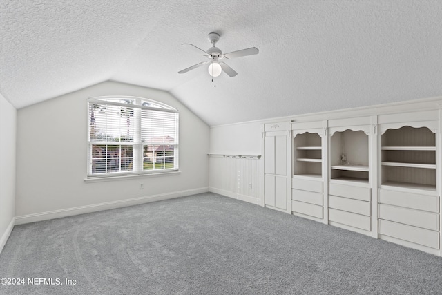 bonus room featuring ceiling fan, carpet flooring, a textured ceiling, and vaulted ceiling