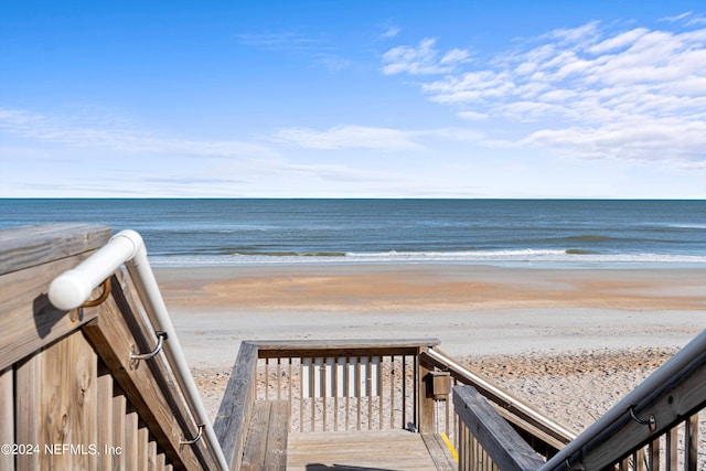 view of property's community with a view of the beach and a water view