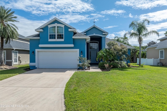 view of front of house with a front yard and a garage